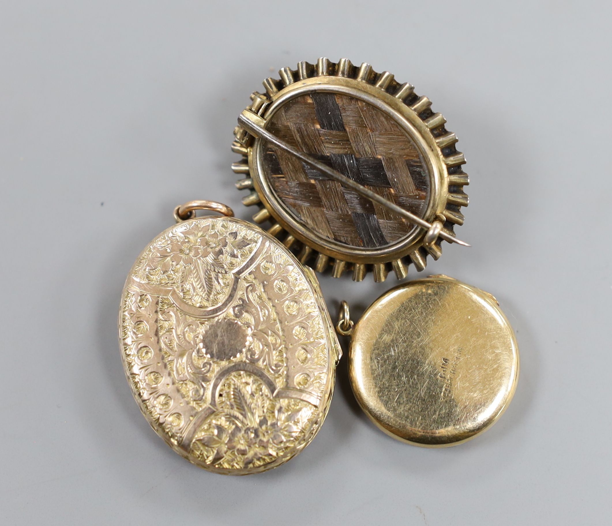 A Victorian yellow metal mourning brooch, with plaited hair beneath a glazed panel verso, 35mm and two engraved lockets.